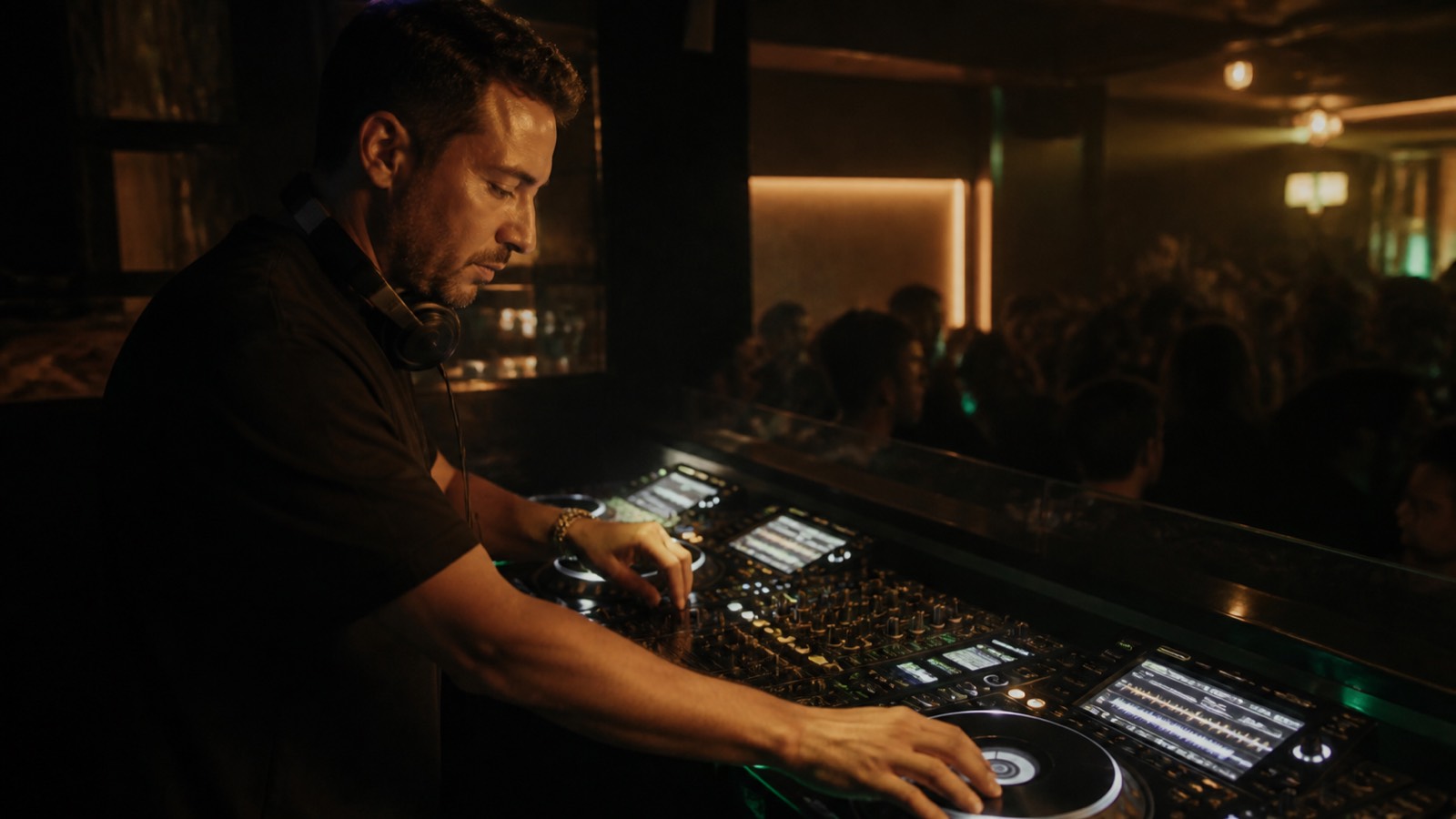 A working house DJ chooses the next track during a professional club set